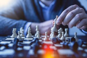 Na imagem, um homem jogando xadrez. Isso representa a forma de como lidar com a concorrência, sempre em busca de novas estratégias.