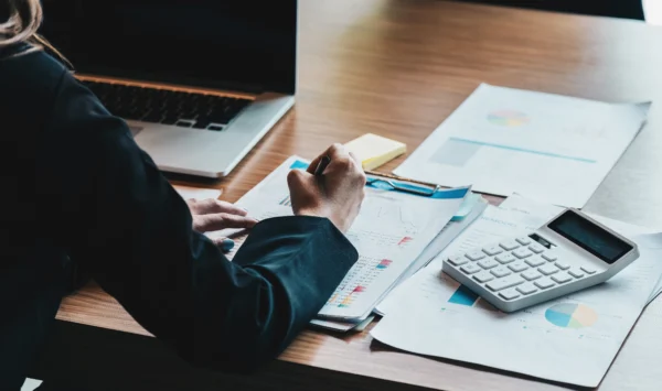 Empreendedor realizando os processos financeiros de sua empresa, fazendo contas.