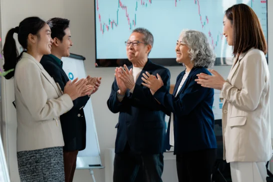 Sócios da empresa celebram rodada de investimento após apresentarem projeto sobre o que é captação de recursos para investidores.