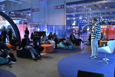 Palestrante em palco do Speed Talking com participantes, ilustrando curiosidades do Asaas Connect.