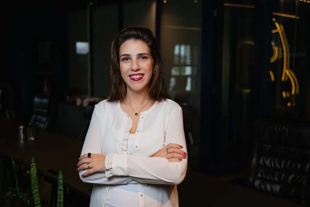 Conheça Aline Steinwascher, CLRO Asaas, de braços cruzados e blusa branca, representando a diretoria da fintech.